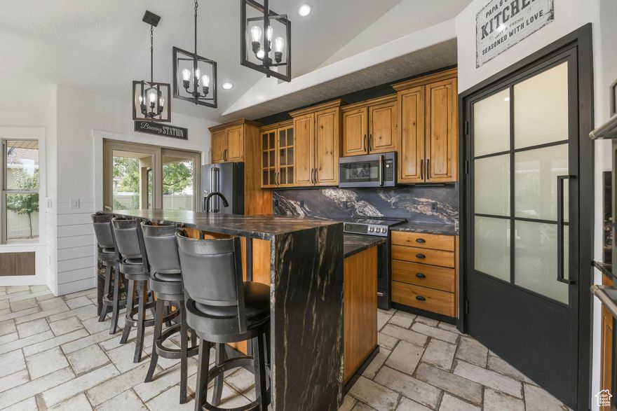 This custom 4-bed, 3.5-bath home (with a bonus room above the garage) has been carefully remodeled by a custom home builder, and it shows in every detail.  Inside, you'll find new flooring, modern lighting, upgraded switches, and bathrooms with brand-new counters and fixtures-everything chosen for both style and comfort. The kitchen is the star of the show, complete with Cafe appliances, three ovens, waterfall granite, tons of cabinetry, and a double-sided fireplace that connects right into the bright family room.  The primary suite feels like its own retreat: a fireplace, a mounted TV, a window seat, and even a hidden Murphy-style closet for a fun, functional surprise. Downstairs, the basement is already set up for flexibility-it's currently set up for a salon but is plumbed for a kitchen and has a large open family room, and a half bath that's ready for a future shower. Perfect for a guest suite, in-law apartment, rental ADU (just needs the kitchen), or even a home business with its own private entrance. There is even new flooring in the cold storage that can be used in the basement if desired.  Step outside and you've got a 1,000+ sq/ft Trex deck, fully furnished, plus a Bullfrog hot tub Add in RV parking, a heated 4 car garage with a car lift, and pre-approval from the city for a detached garage or ADU, and the options here are wide open.  This home is fully loaded with thoughtful upgrades, tons of functionality, and unique character you just won't find in brand-new builds. Check out the 3D Tour and schedule your showing today!