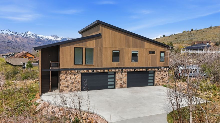 This is a dream listing! Completely turnkey and fully furnished, just show up and start living. Only 8 minutes to the lifts, yet tucked into your own private creekside setting, this home was custom designed with intention in every detail. Upper-level living captures panoramic mountain and valley views, with 10- to 20-foot ceilings and exposed I-beams that create a space that feels open, elevated, and truly one of a kind.  Situated on a 0.6-acre natural foliage lot with virtually no yard maintenance, this home is built for seamless everyday living. It features 2 bedrooms, 3 bathrooms, and a dedicated office or flex space, along with a heated oversized 4-car garage measuring 53' by 32' with 10-foot ceilings, 9-foot doors, epoxy floors, and extensive storage. Perfect for mountain gear, recreational vehicles, or a versatile flex space. Enjoy year-round living with a hot tub, cold plunge, covered deck with gas firepit, and a lower patio, all enhanced by Sonos sound throughout.  Built for comfort and efficiency, the home features engineered construction, foam insulation, sound-dampened walls, a tankless water heater, and high-end finishes throughout.  Fully wheelchair accessible, the home also includes an elevator, making daily living and transporting groceries effortless.  This is not your typical mountain home. Experience it for yourself