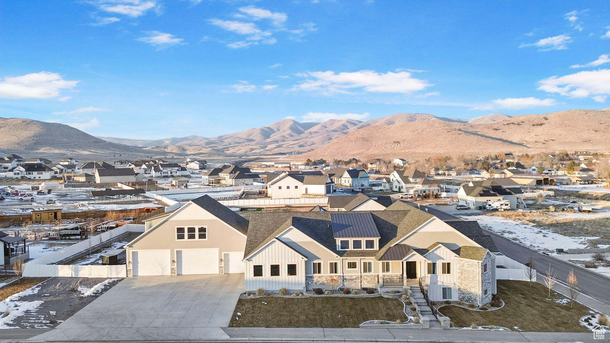 This extraordinary one of a kind custom home is nestled on a generous 1.03 acre lot in beautiful Eagle Mountain, Utah. The location offers the perfect blend of country living with modern convenience. This remarkable home features over 9500 SQ FT of luxury living, an unparalleled TWELVE car garage, TWO complete Mother in Law apartments (perfect for multigenerational living, a guest retreat, or an income-producing rental space) and stunning views.   Being a contractor's personal home, no time or expense was spared to ensure quality craftsmanship and to include a multitude of upgrades and extras! Every single detail of this home was designed to exceed expectations! As you enter this gorgeous estate, you'll immediately feel luxury AND comfort. The main floor boasts an open concept living area including vaulted ceilings with wood beams, large windows, a 48" custom fireplace, hickory hard wood flooring, a sound system featuring speakers throughout the home, high-end carpet/pad, 4' wide custom hallways with automatic lighting, 2X6 walls for upgraded insulation and double insulated floors for sound. Additionally, on the main level you will find a gorgeous primary suite with luxury en suite bathroom and easy laundry room and deck access. You'll also find a large den/office space and 4 additional bedrooms on the main floor (including a guest suite with private bathroom). The mudroom includes a drinking fountain and "Costco door" to unload your groceries right into the extra-large pantry!   For the culinary connoisseur, this gourmet kitchen has it ALL! Double Granite islands (3-inch granite throughout the home) with island seating for 8, high-end Sub-Zero refrigerator, WOLF appliances, double oven and 60" WOLF gas top with griddle, a separate ice maker, a pot filler, custom range hood, reverse osmosis system for kitchen and drinking fountain and custom cabinetry with soft close.  For little ones, custom slide out step stools assist the smallest kitchen helpers!   The lower level of this home features a large family/bonus room area and two FULL Mother-in-Law quarters, each with separate exterior entrances. Each Mother-in-Law space includes a full kitchen with custom cabinetry, a family room and laundry room. Both include LVP flooring with carpet in the bedrooms. One of the Mother-in-Law dwellings has 3 bedrooms/2 bathrooms and is a legal apartment with separate utilities (except gas) and includes a primary suite. It is approximately 2300 SQ FT. The second Mother-in-Law dwelling has 2 bedrooms, 1 bathroom and is approximately 1900 SQ FT.  The lower level boasts plenty of natural light and 9' ceilings throughout.  For car/garage enthusiasts... you will NOT believe this garage!!!!! It is UNBELIEVABLE!!!! 12 car extra wide, extra deep and extra height make this garage a safe haven for all vehicles, toys, boats, trailers, etc. The garage includes a large storage room and utility sink. There is additional unfinished square footage above the garage that is stubbed for utilities that could be finished for additional living quarters. If you still need room for your RV there is additional RV parking on the west side of the home with four 8' access gates (when two are open, it provides 16' access). The property's generous back yard acreage is fully fenced and includes an in-ground trampoline and large play set. A covered TREX deck and patio make the most of outdoor living! This beautiful back yard provides a canvas for unlimited landscaping possibilities as well as potential horse/livestock property options.   There are SO many extras that it's impossible to list everything! From seismic upgrades, four 96% efficiency furnaces including  zone system, built in humidifier and filtration system for the furnaces, make-up air system with silencer for fresh air, four water heaters with "insta-hot", wiring allowing a generator to be plugged into the home to run all major appliances (refrigerator, furnace, etc) in the event of an emergency/outage, hidden Chr