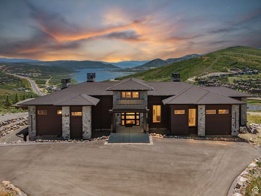 Modern mountain living reaches new heights in the gated community of Deer Vista. This custom built home focuses on every detail in it's smart floor plan, making everyday tasks more intuitive and creating a sense of order and harmony throughout. Designed and built by Modern Design in 2024, this 4,555 sq ft home offers 4 bedrooms, 6 bathrooms, and an effortless blend of form, function, and breathtaking views.  Set above Jordanelle Reservoir with  unobstructed sight-lines of water, mountain, and Deer Valley, the home was designed around forever trophy views. Expansive living spaces flow seamlessly into one another, anchored by a sleek open floor plan and framed by thoughtfully placed windows that capture natural light and endless vistas. The spacious patio extends your indoor/outdoor living space - The elevated outdoor space is perfect for relaxing, hosting, or taking in Utah's four-season beauty. Inside, clean architecture and elevated finishes create a refined yet comfortable atmosphere, ideal for both everyday living and weekend escapes. Located just 15 minutes from Deer Valley's new East Village, with easy access to Park City's Main Street and a direct 45-minute drive to Salt Lake International Airport, this home pairs privacy with proximity in all the right ways.