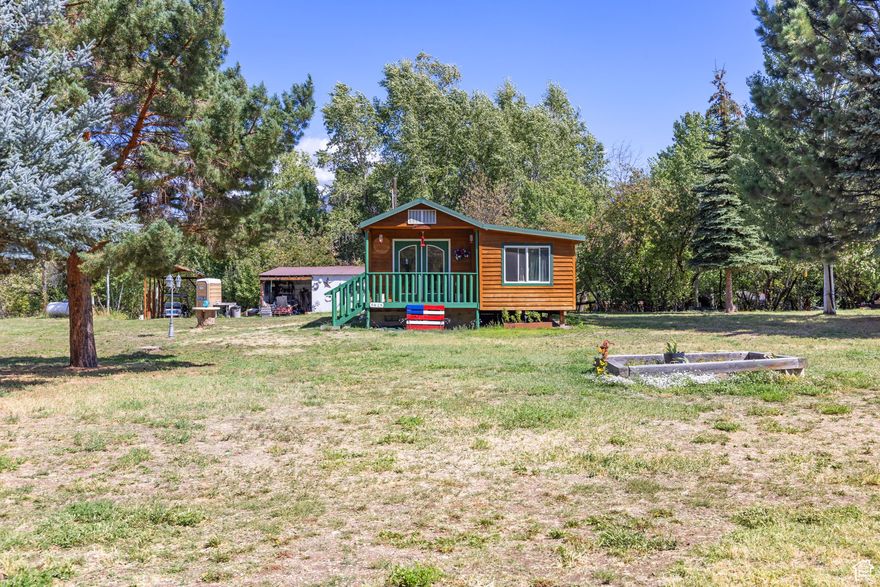 FULLY FURNISHED! Set on nearly two acres just outside  Cache National Forest, this 1 bedroom home is exactly the kind of setting people drive hours to find! With no CC&Rs or HOA, you can bring the four wheelers, snowmobiles, and camping gear without anyone telling you otherwise. The property stacks up to year round forest access, so trails are right out the door whether you're hiking in summer or riding in winter. The yard has already been set up as the ultimate gathering spot, with outdoor tables, a covered cooking area, and room for RVs. Works well for family reunions or weekends with friends. In the spring and early summer, a small stream cuts across the property, adding to the mountain feel. Inside, the home is simple and easy to maintain, giving you a basecamp that doesn't require constant upkeep. Whether you use it full time or as a weekend place, it's built to let you spend more time outside enjoying the property and less time working on it.