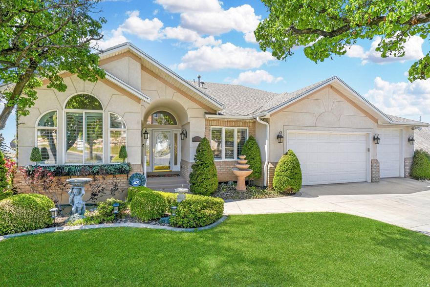 Welcome to this beautifully designed rambler with a timeless brick-and-stucco exterior offering an exceptional blend of elegance, comfort, and functionality, complete with a three-car garage that can be converted back to a four-car configuration. A grand entry opens to formal living & dining rooms with soaring vaulted ceilings, creating an inviting setting for entertaining, while a versatile bedroom near the front door features a built-in Murphy bed & direct access to a half bath, ideal for guests or a home office. The gourmet kitchen is the heart of the home, showcasing two-tone custom cabinetry, a large center island, Wolf induction cooktop, breakfast bar, updated countertops, tile backsplash, upgraded lighting, and solid oak hardwood flooring, flowing into a sunny breakfast nook with a bay window & oversized window that frame breathtaking valley views. The adjoining great room features a cozy gas fireplace & a full wall of custom built-ins with LED accent lighting, & the covered back deck offers sweeping valley & sunset views with the added comfort of a power sun shade. The luxurious main-level primary suite is a private retreat with a sitting area & fireplace, stunning views, direct deck access, & a spa-inspired ensuite with a jetted tub, double vanity, separate shower, & an expanded walk-in closet created from part of the fourth garage bay. The bright walkout lower level provides exceptional versatility with a full second kitchen, three additional bedrooms, two bathrooms, a spacious gathering area with a fireplace, a bonus room ideal for a theater or game room, abundant storage, including a massive unfinished room, & a welcoming three-season covered porch with direct access to the landscaped backyard featuring flower beds & a firepit. Additional upgrades include permanent holiday lighting & a whole-house backup generator, all ideally located near shopping, dining, and recreation, making this home a rare blend of refined living and unforgettable views.