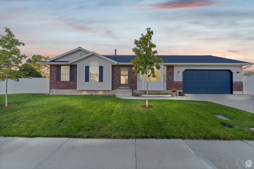Welcome to this stunning Lehi rambler perfectly situated on a desirable corner lot! From the moment you arrive, you'll fall in love with its incredible curb appeal, mature landscaping, and ample parking. Step inside to a bright and welcoming family room filled with natural light and a ceiling fan, the perfect space for everyday living. The kitchen is truly a chef's dream, featuring a spacious peninsula island with bar seating, stainless steel appliances, tile flooring, and a semi-formal dining area that flows seamlessly to the backyard through sliding glass doors. Upstairs you'll find three comfortable bedrooms and two full bathrooms, including a generous primary suite complete with its own en-suite bath. The fully finished basement adds even more living space with two additional bedrooms, a beautifully remodeled three-quarter bathroom with custom tile work and vanity, and a large family room ideal for movie nights or gatherings with friends and family. You'll also appreciate the storage room with custom built-in shelving and an extra-deep two-car garage offering plenty of room for tools or toys. Outside, the backyard is an entertainer's paradise, enjoy summer barbecues on the expansive patio, relax in the hot tub, or make use of the dog run, large shed, and RV parking. Major updates include a new HVAC system (2017), new water heater and softener (2017), and a new roof (2022), giving you peace of mind for years to come. You're walking distance from multiple Schools. Close proximity to Costco, Home Depot, Tons of shopping, and Cornbellys. Take advantage of the close proximity to the new luxury Lehi Family park and several other parks just minutes away. Enjoy the close proximity to the freeway and all of the things of employment amenities. This home truly checks every box, style, space, and updates, all in an unbeatable Lehi location! Buyer and Buyers agent to verify all information. Square footage figures are provided as a courtesy estimate only. Buyer is advised to obtain an independent measurement.