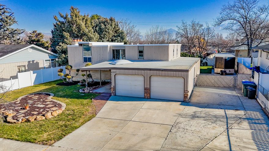 Welcome to a one-of-a-kind home in a beautiful great neighborhood in the heart of West Valley City!  This beautifully updated 4-bedroom, 2-bathroom home offers plenty of storage space for everyone.  With an open large split entry, it's designed for comfort and convenience.   The spacious kitchen flows onto a large deck  ideal for summer BBQ's and family gatherings  while the generous backyard provides room for the kids to play and adults to relax!  Recent upgrades include new roof and windows installed in 2025.  Freshly painted exterior siding and new flooring in the kitchen and Master bath.  Upstairs bathroom was totally remodeled with new tub, flooring, and tile the double sinks in bathroom to make mornings easier.  Also, the master suite boasts a luxurious jacuzzi tub for unwinding after a long day.  The home features a separate basement entry leading to a large laundry/ mud room perfect for busy family life.   Dryer can be gas or electric and the upstairs range has a gas pipe running underneath if you would like gas range.  With a two-car garage, a large workshop, and extra storage space under the patio.  You'll have space for bikes , holiday dcor and lawn equipment.   Located close to schools, shopping, and freeway access.      This home combines convenience with comfort  ready for your family to move in and make memories!