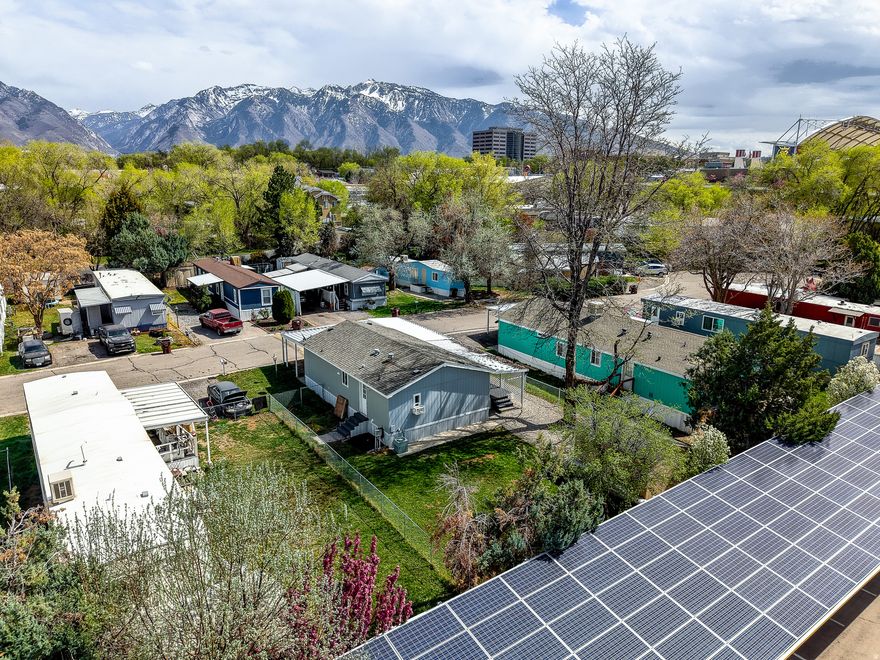 Welcome to this well-maintained double-wide mobile home ideally located near 90th South and just minutes from America First Field (formerly known as Rio Tinto Stadium), shopping, dining, and easy freeway access. Offering three bedrooms and two bathrooms, this home features a functional and comfortable layout with an open-concept living, dining, and kitchen area-perfect for everyday living and entertaining. The primary suite is privately situated on one end of the home, complete with a walk-in closet and an en suite three-quarter bathroom. Two additional bedrooms and another three-quarter bathroom are located on the opposite side, providing separation and flexibility for guests or a home office. Enjoy outdoor living with a large, covered porch, a fully fenced yard with fresh seeding, and a storage shed for added convenience. With five dedicated parking spaces, this property offers rare flexibility for vehicles, guests, or recreational needs. Whether you're looking for an affordable primary residence or a smart alternative to renting, this home offers comfort, space, and a great Sandy location. Schedule your showing today!