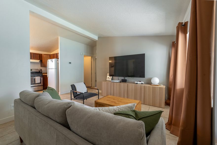 Welcome to this well-maintained double-wide mobile home ideally located near 90th South and just minutes from America First Field (formerly known as Rio Tinto Stadium), shopping, dining, and easy freeway access. Offering three bedrooms and two bathrooms, this home features a functional and comfortable layout with an open-concept living, dining, and kitchen area-perfect for everyday living and entertaining. The primary suite is privately situated on one end of the home, complete with a walk-in closet and an en suite three-quarter bathroom. Two additional bedrooms and another three-quarter bathroom are located on the opposite side, providing separation and flexibility for guests or a home office. Enjoy outdoor living with a large, covered porch, a fully fenced yard with fresh seeding, and a storage shed for added convenience. With five dedicated parking spaces, this property offers rare flexibility for vehicles, guests, or recreational needs. Whether you're looking for an affordable primary residence or a smart alternative to renting, this home offers comfort, space, and a great Sandy location. Schedule your showing today!