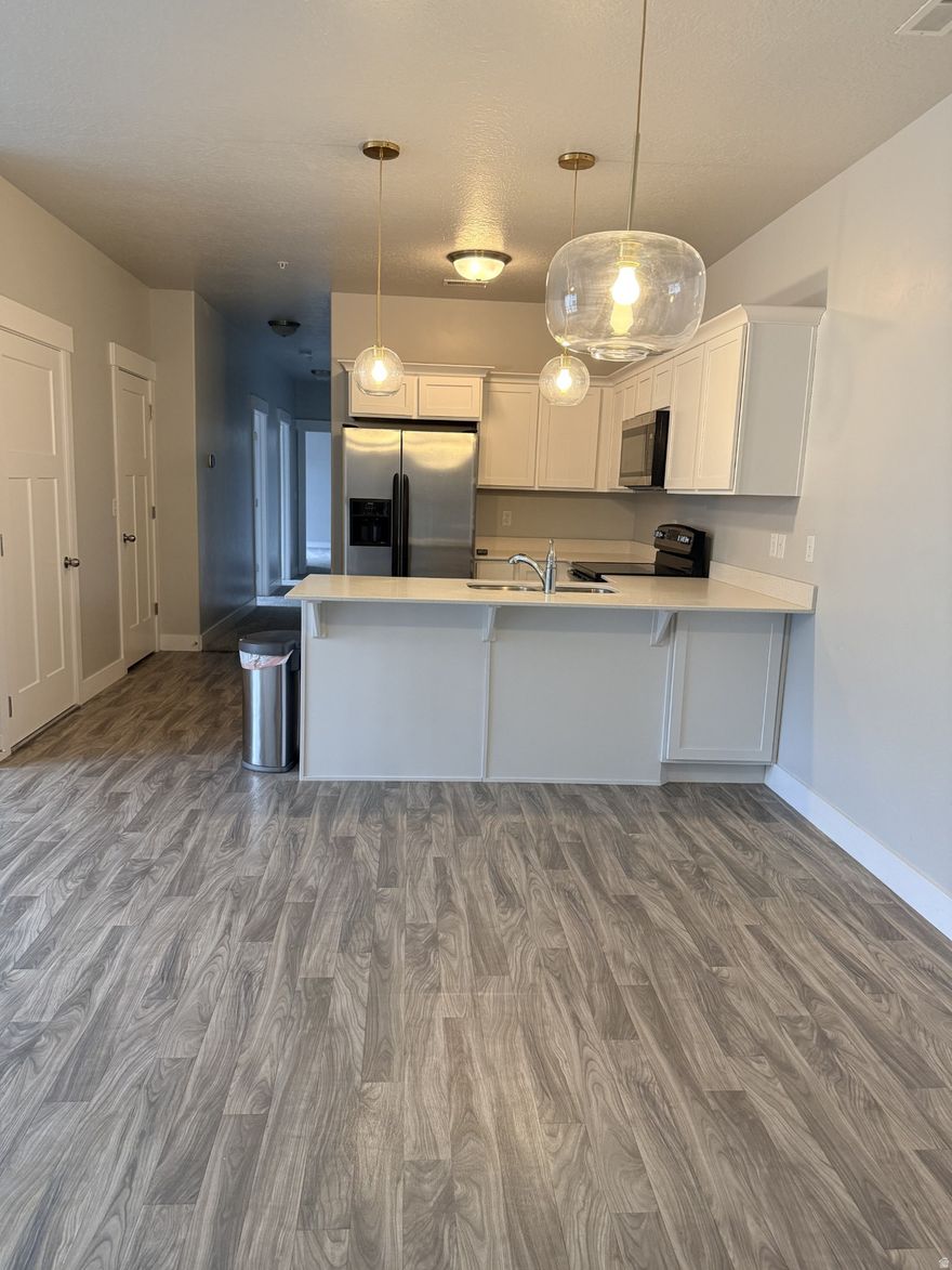 Welcome to this beautiful MOVE IN READY, 3 bed/2 bath condo.  With new, upgraded, plush carpet throughout. and water softner. The primary bedroom boasts a large walk-in closet and an en-suite master bath. Enjoy coffee in the mornings and grilling in evenings on the spacious covered balcony. Located in the perfect area, schools, restaurants, parks, grocery stores, movie theaters, shopping, hiking and biking trails are all withn walking distance. Easy access to Bangerter Highway, Mountain View Corridor, and a short distance to I15. Square footage figures are provided as a courtesy estimate only and were obtained from cpinty records. Buyer is advised to obtain an independent measurement. Washer/Dryer and BBQ grill are all negotiable. Make this your new home and be in before spring!