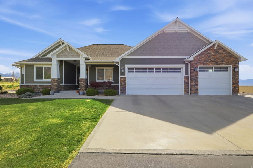 ACREAGE + SHOP + BARN + WATER RIGHTS-ALL IN ONE PROPERTY! This spacious 5,144 sq. ft. rambler delivers 6 bedrooms, 3.5 baths, and the lifestyle everyone wants but few can find. Situated on 4.7 acres fully fenced surrounded by mature landscaping with lush greenery, pine trees and a peaceful rural setting. The property includes a custom 3-stall equestrian barn with ample space for tack and feed, along with a large shop equipped with heating and A/C-ideal for equipment storage, workshop use, or recreational space. A private well with 2 acre-feet of valuable water rights along with energy-efficient solar panels.  Inside, you're welcomed by a beautifully finished entry with custom trim and casing, leading into a vaulted family room complete with surround sound-perfect for entertaining. The chef's kitchen is built to impress with a gas cooktop, double ovens, vented hood, thick edge granite countertops and stylish two-toned cabinetry.  The oversized bedrooms provide space for everyone, while a dedicated gym area with rubber flooring adds even more functionality. The primary suite is a true retreat featuring a recessed ceiling with accent lighting and trim, the sliding glass door opens directly to breathtaking views where your hot tub awaits on the connecting patio.  The spa-like primary bath includes a freestanding tub and euro glass shower. Additional upgrades include a reverse osmosis system and whole-home humidifier for year-round comfort.