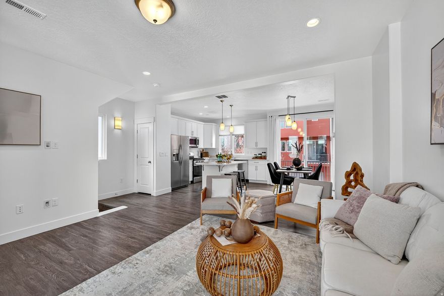 Urban Living meets open, functional spaces in this updated home located within walking distance of Trax, University of Utah Hospital, and the new Baseball Field with grocery and dining 3-5 minutes away and schools within a couple blocks of walking as well.  This home features space enough for living and a bonus home office or flex space on the main floor, with 9 foot ceilings on each level, laminate flooring on the main and throughout the kitchen, dining and family room, extra tall white cabinets with quartz counters, and a stainless steel appliance package and 2 Master EnSuites featuring a private balcony and oversized bathroom with dual vanities, quartz counters, and Euro style glass surround shower with a private toilet room and walk in closet.  With the extra energy star ratings on this home, shut the doors and the home becomes a peaceful escape from the outside world with superior insulation package.  Plenty of room for a small outdoor private yard setting for pets to roam, and located in a courtyard with open greenspace.   Don't forget the oversized, extra deep garage to fit your truck or toys likes paddleboards and bikes with extra room to spare!  For all the Amenities and HOA information visit  https://www.daybreakutah.com/community-association/