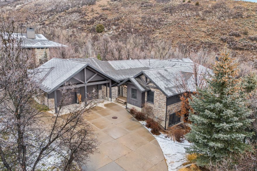 This stunning custom modern mountain home blends seamlessly into the breathtaking natural surroundings of the exclusive **Cottages at Hobble Creek** development, offering unmatched privacy and tranquility in scenic Hobble Creek Canyon, Springville. Exceptional craftsmanship shines throughout, with wood frame windows, radiant floor heating on both levels and heated driveway, and year-round comfort. The gourmet kitchen features a Viking gas cooktop, pebble ice maker, and double ovens. Separate formal dining and living rooms provide perfect spaces for entertaining. The private master suite opens to a deck with a dual-sided gas fireplace, ideal for cozy relaxation and panoramic views. Starlink internet keeps you connected. The Full walkout basement is guest-ready with a wood-burning fireplace, separate shower/toilet in each bathroom, dedicated laundry room, and an additional main-level guest bedroom. Ample storage enhances everyday functionality. Two 1,000 underground propane storage tanks connected to a backup generator, you will never have disruptions in power. The home's boiler and recirculation system will provide endless hot water. 100 yr shingles.  Enjoy the soothing sounds of the stream at the property's edge. Conveniently located near the renowned **Hobble Creek Golf Course**, National Forests, parks, and a family recreation pond, this exceptional home offers serene mountain living at its finest. **Furnishings may be negotiated for a full turnkey opportunity.** https://jc-real-estate-media.aryeo.com/sites/121-oakwood-dr-springville-ut-84663-22134189/branded County Record SF is inaccurate, sf was obtained by certified appraiser.  Square footage figures are provided as a courtesy estimate only.  Buyer is advised to obtain an independent measurement.
