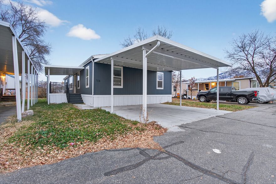 Beautiful 4-bedroom, 2-bath manufactured home soon to be part of the brand new Wasatch Ranch Community in Pleasant View. This home features fresh interior finishes, LVP, a spacious living room, and a stunning kitchen with upgraded cabinetry and stainless steel appliances. The primary suite includes a walk-in closet and double-sink vanity, with three additional bedrooms offering great flexibility. Enjoy a large private deck, covered parking, and a move-in-ready feel throughout. Wasatch Ranch will offer brand-new amenities and an affordable, modern community in a highly desirable location.