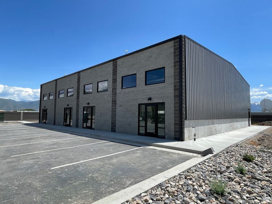 Prime Light Industrial Space in Spanish Fork!   With high ceilings, a large garage door, I-1 zoning, it's ideal for a variety of business uses. The space includes a bathroom, while the rest remains open for versatile use to transform to fit your specific needs. Set for completion this summer, this is a great opportunity to secure a high-quality space in a growing area.   Rent rates can potentially go down with longer lease. Contact agent for more information.  Buyer and buyer's agent to verify all information, including square footage, zoning, and permitted uses. Information is deemed reliable but not guaranteed.