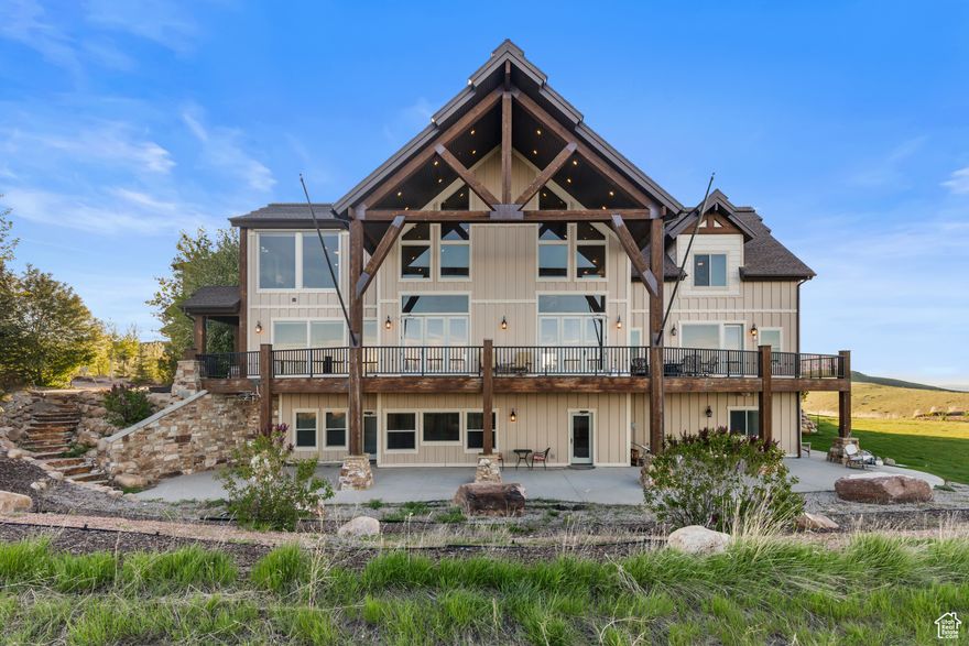 Spectacular Estate in The Reserve at Bear Lake  16+ Acres with Unmatched Views. Perched on 16.22 acres in the prestigious gated community of The Reserve, this extraordinary 12,145 sq ft mountain estate offers breathtaking panoramic views of Bear Lake, the surrounding valley, and mountains. Designed for luxury living and unforgettable gatherings, the home features 13 spacious bedrooms, 9 1/2 bathrooms, and comfortably sleeps up to 45 guests in beds---perfect for extended families, retreats, or vacation rental potential. Entertain with ease in the expansive great room, highlighted by a soaring ceiling, stunning stone fireplace, and custom built-ins. The gourmet kitchen boasts double wall ovens, two dishwashers, a double refrigerator, and a commercial-grade pantry complete with a fridge/freezer combo, a 2nd fridge and 2 freezers. The large dining area and adjacent family rooms provide plenty of space for large groups to gather. The layout includes three family rooms, a massive upper-level office with sweeping views, and a 901 sq ft indoor sports court. Step outside to a terraced yard designed for fun and relaxation-complete with a playground, tetherball, horseshoe pit, and an oversized deck and patio area. The main-level master suite is a private retreat with a large walk-in closet, soaking tub, walk-in shower, and private deck access via a slide for added fun. Enjoy mature landscaping, privacy, and exclusive access to The Reserve's outstanding amenities, including two seasonal heated pools, a year-round hot tub, clubhouse with fitness center, covered poolside pavilion, sports courts, playground, and gated beach access. This one-of-a-kind property is a rare opportunity to own a legacy home in one of Bear Lake's most sought-after communities. Sold mostly furnished.