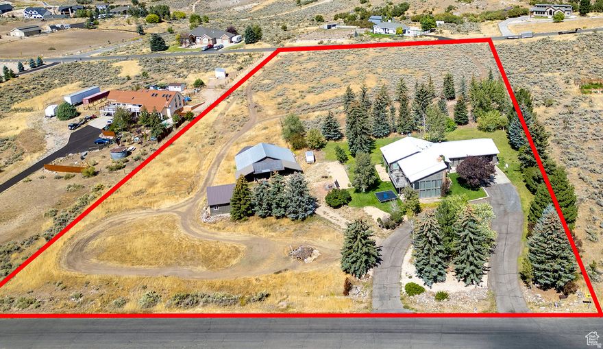 Rare opportunity to own a piece of Wasatch View Acres! Great home offering unique midcentury modern architecture situated on 5 acres with barn and workshop. Approx. 5100 sq feet offering 6 bedrooms, 3 bathrooms, walkout basement, updated kitchen and attached 2 car garage. Many possibilities with this great home and property! Perched above Heber, this great location offers stunning mountain and valley views with easy access to city amenities and schools. 55 minutes to SLC international airport, 40 minutes to Provo/Orem. Buyer to verify all.