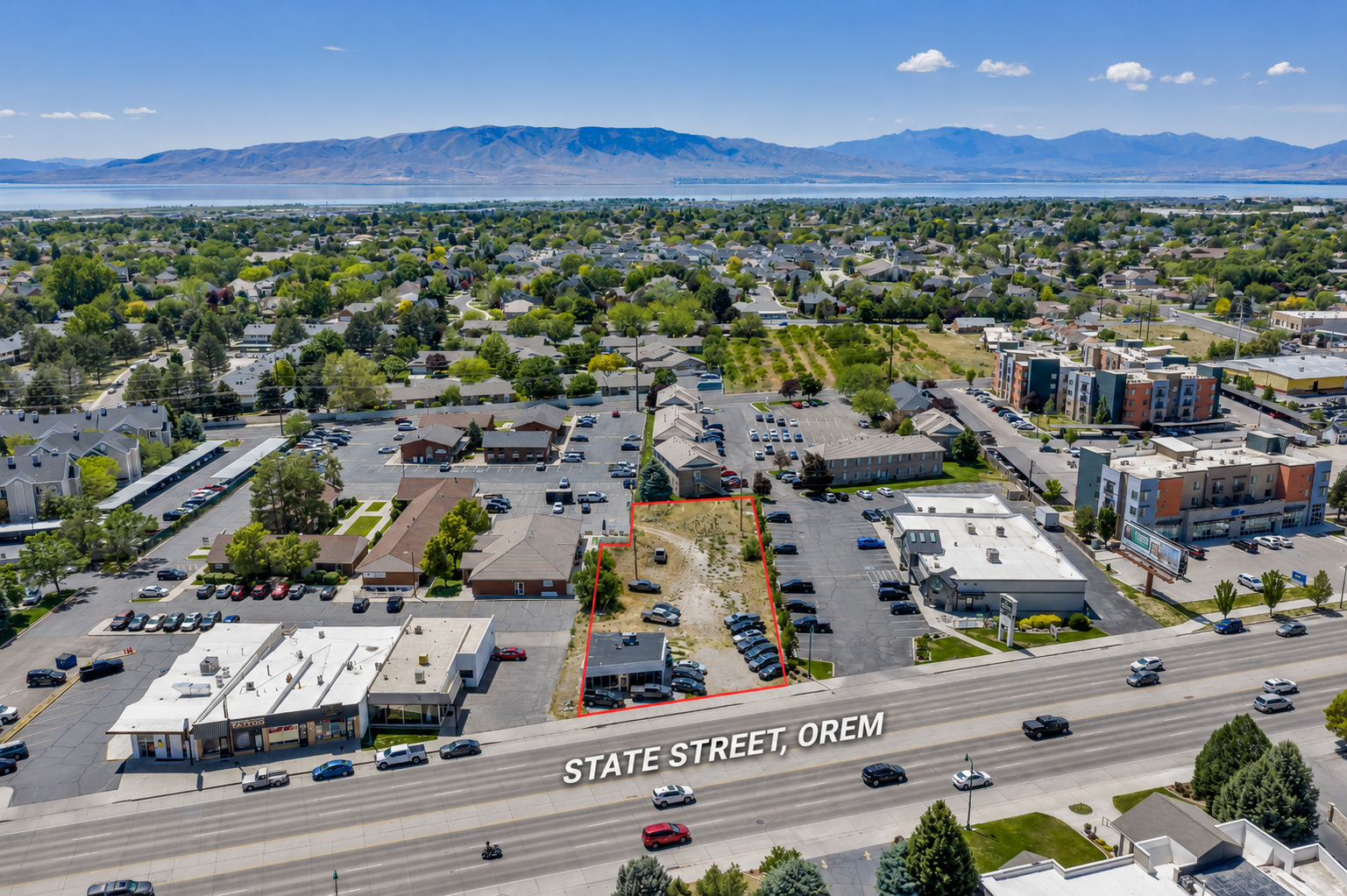 Aerial perspective highlighting a commercial property with significant frontage on State Street, Orem