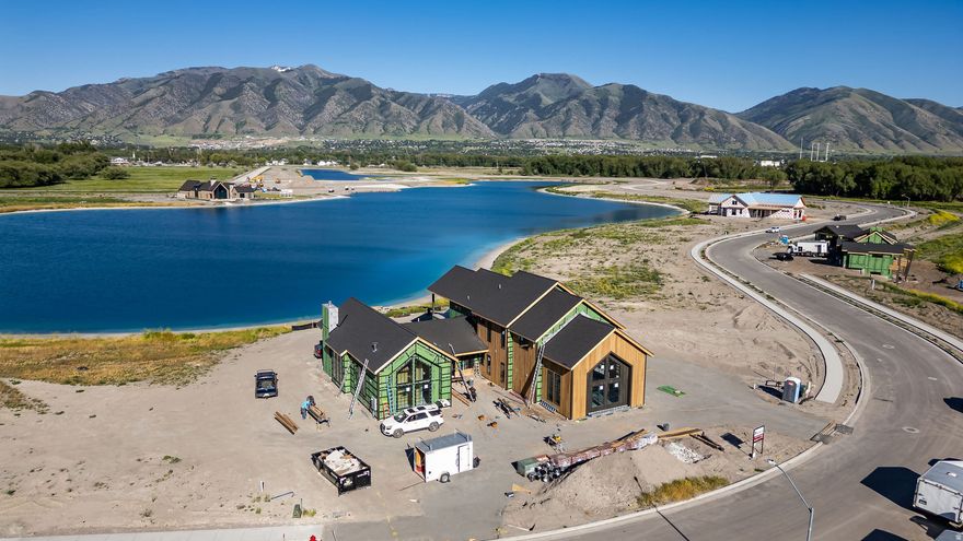 LUXURY BEACHFRONT LIVING IN THE EXCLUSIVE WILLOW LAKES COMMUNITY! This stunning lakefront retreat showcases elevated mountain-modern design with expansive windows, premium finishes, and breathtaking panoramic views of the Surf Lake and the Bear River Range. The oversized second-story viewing deck creates the perfect setting to take in Cache Valley's incredible sunsets and waterfront scenery.  Thoughtfully designed for both entertaining and relaxation, the home features a real cedar exterior, spacious bedrooms with private ensuite bathrooms, a dedicated bunkroom, and seamless indoor-outdoor living with a white sandy beach just steps from the back deck.  Enjoy full access to the unmatched Willow Lakes lifestyle, including private beaches, trails, Logan River access, pickleball courts, pool and hot tubs, and a spectacular 30,000 sq. ft. clubhouse and fitness center complete with spa-style amenities.  Recently recognized by World Atlas as one of the Top 10 Resort Towns in the USA, Logan offers year-round recreation, natural beauty, and an exceptional mountain-lake lifestyle unlike anywhere else. Call today for a private showing or to receive a copy of a virtual video tour.
