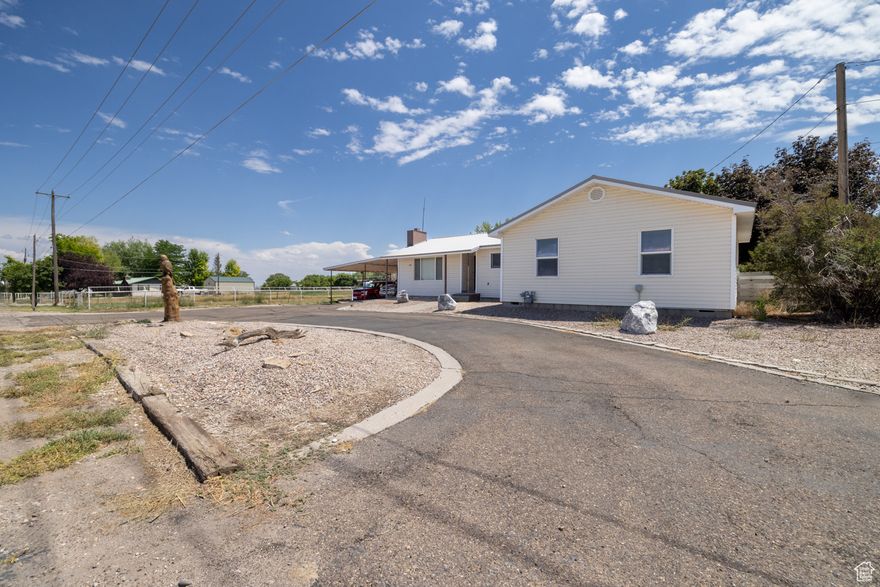 3 bedroom, 2 bathroom 2082 sq feet home on 2.25 acres.  Pasture has sprinkling system with .07 premier, 3.00 S-Stock water shares.  Metal roof is 5 years old; vinyl siding 5 years old; 5-ton central air conditioner/heater 3 years old. Generac generator 26KW well service house and all sheds, runs off natural gas and has hook ups for propane.  Solar Panels, gas fireplace, woodburning stove.  Three outdoor sheds: Shed #1 has 6 cords of wood all cut and stacked for fireplace. Shed #2 makes an ideal workshop or storage with electricity.  Shed #3 makes an ideal playhouse for the little ones.  Trex custom patio deck and two large shade trees.  50 amp breaker RV plug in front yard with sewer clean out.  5 car carports with additional workshop with electricity and AC.  Square footage figures are provided as a courtesy estimate only and were obtained from county records. Buyer is advised to obtain an independent measurement.