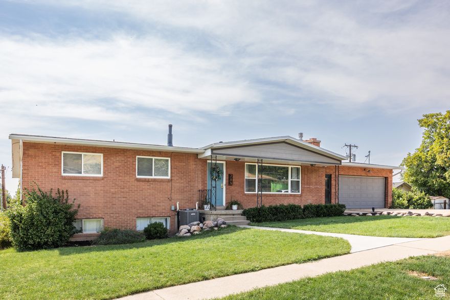 For those who love homes with mid-century charm, but appreciate an open floor plan and modern conveniences, this Kaysille rambler is likely a welcome sight. An inviting entry flows into a formal living space anchored by original hardwood floors and a beautiful stone fireplace, creating the perfect spot for reading, a music room, or a casual happy hour with friends. Seamlessly connected to the open kitchen and spacious family room, you'll find that this is a great home for entertaining-pull up a stool to the roomy bar, where everyone can help cook or chat with those who are simply enjoying the second fireplace, huge windows, and vaulted ceilings in the great room (think: ideal spot for Super Bowl parties). From there, a pair of charming French doors walk out to a large deck, and another door on the opposite walls walks out to the yard, maintaining an effortless flow from inside to outside. With three bedrooms and two bathrooms on the main, you could easily spend most of your time on the main level, but for those who need a bit more space, you'll find another two bedrooms and one bathroom in the fully finished, walkout basement (with a full kitchen to boot!). Whether you decide to rent it out for a little extra help with the mortgage, or take advantage of the perfect space for the ultimate game room and movie lounge, you'll be well equipped. Where outdoor space on this property is concerned, there are endless possibilities-be it for pets, a garden, or just ample room to romp-and the extra wide parking ensures you've got a spot for your camper, boat, or whatever else you can dream up. Being just a stone's throw from Route 89, your commute in either direction will be a breeze, and you'll be well connected to just about everything you need. All told, this comfortable abode plays for keeps.