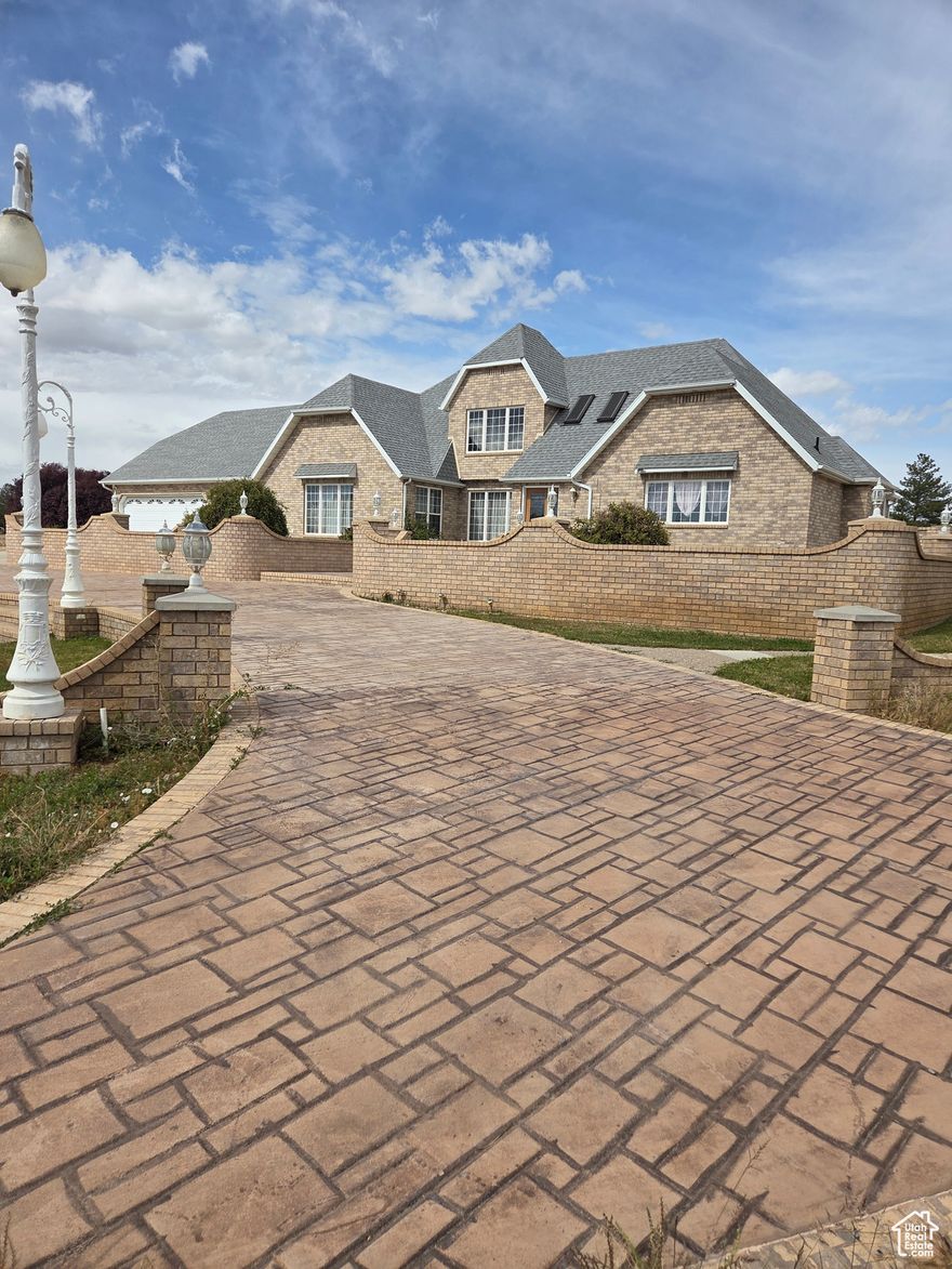 Spacious & Stunning Brick Home on a Corner Lot with Endless Possibilities!   From the exterior to the interior, this impressive brick home offers over 5,200 sq ft of living space, featuring 4 bedrooms and 3 bathrooms. The timeless brick exterior and brick driveway add classic curb appeal and durability, while the corner lot location provides extra space, privacy, and beautiful street presence.  Step inside to an open layout filled with natural light and skylights, creating a warm, inviting atmosphere. A gorgeous natural gas fireplace adds the perfect touch of comfort and charm to the main living area. The walkout basement, already 15% finished, offers plenty of potential-expand into a second kitchen, a large family room, game room, or even a guest suite.  The basement has been plumbed for an additional bathroom. The possibilities are endless!  Outside, enjoy sweeping views of the surrounding mountains and valley floor, multiple decks and patios, and a gazebo plumbed for a hot tub-perfect for entertaining or relaxing under the stars. This home combines elegance, comfort, and stunning views in one incredible property.