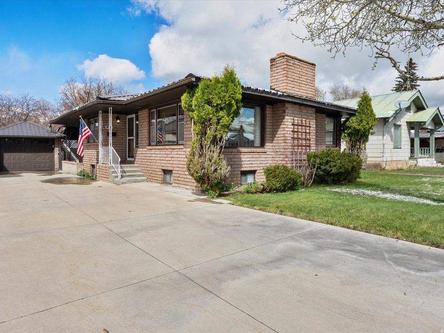 Welcome to a beautifully maintained brick rambler offering space, versatility, and timeless character. With 6 bedrooms, 3 bathrooms, and 2,670 square feet, this home is perfectly suited for large families, multi-generational living, or anyone looking for extra room to spread out. Step inside and enjoy the warmth of hardwood floors and inviting living spaces filled with natural light. The main level features a functional layout with a convenient laundry area and primary bath, making everyday living easy and efficient. Downstairs, a standout feature awaits-a large basement space with its own separate entrance, offering endless possibilities. Whether you envision a private suite, entertainment area, or oversized bedroom retreat, this flexible space adapts to your needs. Outside, the home continues to impress with a fully usable, full sprinkler system, fenced backyard, ideal for relaxing, entertaining, or enjoying quiet evenings. A covered patio provides the perfect gathering spot. This home has a durable brick exterior adding to quality and curb appeal, a detached garage for storage or parking, and is in a desired central location.