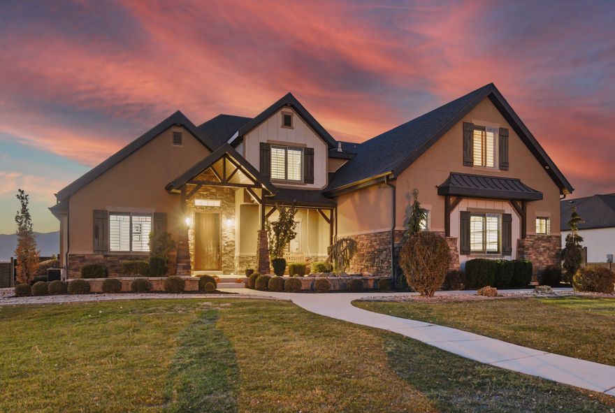 Luxury Custom Estate with Dream Detached RV Garage! Prepare to be impressed by this one-of-a-kind home that perfectly blends elegance, function, and space. Sitting on over half an acre with incredible mountain and lake views, this custom-built estate offers 8 bedrooms, 5 baths, and over 6,500 square feet of luxury living.  Car enthusiasts and hobbyists will love the 7-car setup, featuring a detached heated RV garage with epoxy floors, perfect for a workshop, collector cars, or extra storage. You'll also find extensive paved parking for boats and trailers.  Inside, you're welcomed by open-concept living, tall ceilings, plantation shutters, and premium finishes throughout. The chef's kitchen features marble and granite countertops, custom cabinetry, and double ovens-ideal for entertaining. The fully finished basement includes a private entrance, perfect for a guest suite or second living space.  Enjoy movie nights in the 11-seat theater room, unwind in the 7-person hot tub, or relax on the spacious deck and take in the sunset views. Every detail has been thoughtfully designed-from the built-in humidifier and water softener to the custom stone-molded fencing and manicured landscaping.  With its unmatched features, views, and garage setup rarely found at this price, this home is truly a rare find.