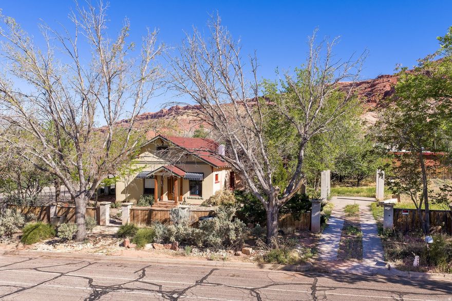 Historic Moab Home on .30 Acre with Incredible Development Potential!    Nestled in the heart of the townblocks of Moab, this historic home sits on a generous .30-acre  with the  development potential of adding two more units.  Featuring three bedrooms and two baths, the residence has been refreshed with new paint and select new flooring, preserving its charm while offering modern updates. Just one block from the vibrant energy of Main Street, this property combines unmatched convenience with the rare opportunity to expand, renovate, or develop further, making it a perfect canvas for those looking to invest in Moab's growing real estate market.  Situated on a spacious lot with room to enjoy the outdoors, the home is filled with natural light from abundant windows that create a bright, airy atmosphere throughout. Two bedrooms are located upstairs, offering privacy and separation from the main living areas. The full bathroom features a distinctive glass block window that adds charm while allowing in soft natural light, and an additional bathroom in the basement provides extra convenience and flexibility.  The generous lot offers space for gardening, entertaining, or future development possibilities.  This is a rare opportunity to own a piece of Moab's history-blending timeless character, light-filled living, and a prime downtown location.