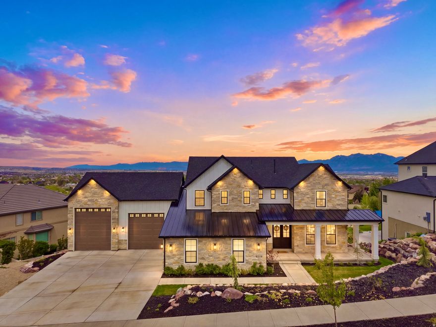 CUSTOM LUXURY ESTATE perched high against the mountainside of Herriman with PANORAMIC VALLEY VIEWS, a SECRET ROOM, a dedicated THEATER ROOM, and countless HIGH-END FEATURES designed for luxury living - all with NO HOA!!! ...***...  Recently completed in 2025, this home is practically BRAND NEW and loaded with HIGH-END UPGRADES throughout.  One-of-a-kind SECRET ROOM hidden behind a heavy VAULT DOOR (no photos available; access granted upon request only).  The dedicated THEATER ROOM features a $50,000 system, including a MASSIVE 172" SCREEN, 4K widescreen projector, an 11-speaker surround sound system, 2 large subwoofers, and concrete-surrounded walls for an immersive movie experience.  The home also includes over $30,000 in UPGRADED INSULATION & SOUND BARRIER PADS for enhanced privacy, soundproofing, and energy efficiency.  MULTI-ZONE HVAC SYSTEM allows separate temperature control for each level of the home for added comfort and efficiency.  High-end finishes throughout the home include QUARTZITE, QUARTZ, GRANITE, and PORCELAIN countertops.  The home also features a MAIN FLOOR PANTRY in addition to a beautiful BUTLER'S KITCHEN, a full MOTHER-IN-LAW KITCHEN downstairs, and 3 LAUNDRY ROOMS - one on each level.  The MAIN LEVEL KITCHEN features a large SUB-ZERO fridge/freezer and a built-in PEBBLE ICE MAKER.  The backyard is prepped for a future ABOVE GROUND POOL with a leveled area and power already installed.  The home is PRE-WIRED for a large outdoor GENERATOR with a concrete pad already in place, and the electrical is also PRE-WIRED for future SOLAR PANELS if desired.  The 5-CAR GARAGE is extra-height and extra-length, featuring an EV CHARGING STATION as well as an RV ELECTRICAL HOOKUP.  The sub-basement features an ADDITIONAL GARAGE for extra storage, RECREATIONAL VEHICLES, or TOYS.  You'll also love the breathtaking VALLEY and FIREWORKS VIEWS during the holidays, the permanent JELLYFISH EXTERIOR LIGHTING, the ELECTRIC BLINDS with remotes/programming on the main level, the high-end DOUBLE PANE PELLA WINDOWS, and the GAS FIREPIT in the backyard.  This home is truly packed with unique features you won't find anywhere else and was thoughtfully designed for PRIVACY, COMFORT, and LUXURY LIVING.  This is the home you've been waiting for - come see it today!  Information and measurements are provided as a courtesy; buyers are advised to obtain their own measurements and verify all information.