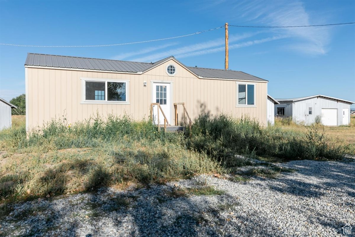 Over 4 Acres of Possibility! Escape the ordinary and embrace the potential of this 3-acre parcel. It features an insulated, wired, and plumbed unfinished tiny home with 1 bedroom and 1 bathroom-ready for your personal finishes. A spacious 4-car detached garage offers ample room for vehicles, tools, or workshop needs. Additional sheds provide more storage. Zoning allows for livestock, so bring chickens, goats, horses and cows. The flat, terrain makes expansion easy, whether you're planning gardens, fencing, or future structures. Located just minutes from town, this property blends convenience with wide-open possibilities. Buyer will need to put in septic system but parcel has a Fairview Water Hookup and electric is already on the property.