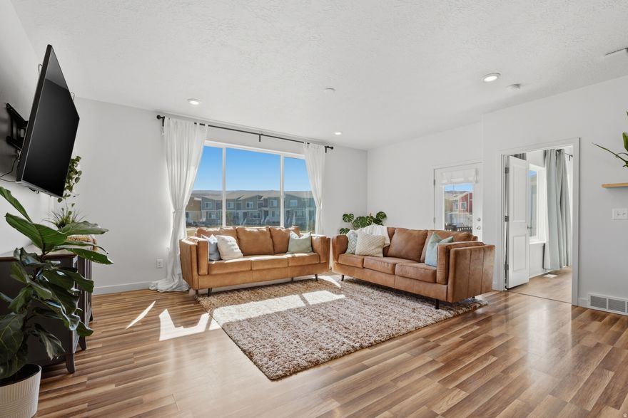 Welcome to this move-in ready end-unit townhouse in Independence at the Point. In addition to its current two-bedroom layout, the unfinished basement space is ready to be completed as a third bedroom, adding immediate value and flexibility.  Conveniently located near extra parking and a neighborhood playground, this home features an open-concept layout with large windows and a bright, inviting feel. The refrigerator is included, and the washer and dryer are available for purchase.  Enjoy the second-story deck overlooking the playground, a perfect spot to relax and take in the views.  Gigabit internet is included in the HOA, along with access to pools, parks, and trails. Additional features include hardwired internet access on all three levels, extra garage storage, and a soft water system. Quick access to I-15 and Redwood Road, keeps you close to everything.  Square footage figures are provided as a courtesy estimate only. Buyer is advised to obtain an independent measurement.