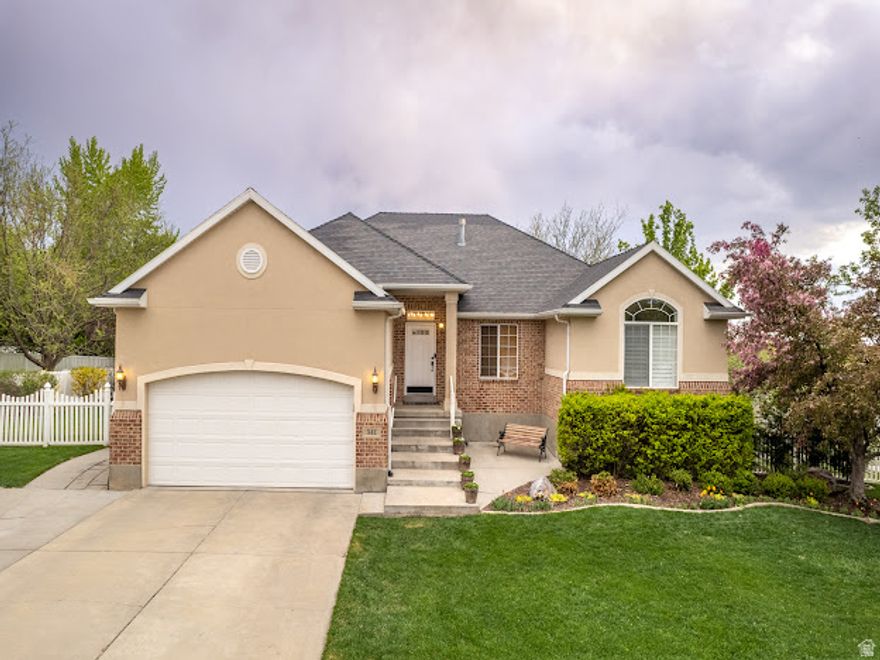 Experience refined living in this stunning ivory residence nestled in the desirable East Lindon community. Designed with timeless elegance, the home welcomes you with a beautifully crafted floor plan highlighted by graceful architectural arches and soaring vaulted ceilings that create an airy, sophisticated ambiance. The interior features an elegant blend of solid-surface countertops, rich hardwood flooring, plush carpet, and tile, complemented by tasteful two-tone paint that enhances the home's warmth and style. Each space is thoughtfully designed to balance comfort with upscale finishes. Set on an expansive 0.46-acre lot, the outdoor setting is equally impressive. The fully fenced and professionally landscaped yard provides both privacy and beauty, offering the perfect backdrop for relaxation or entertaining. Enjoy peaceful evenings or weekend gatherings on the 109 covered deck, overlooking the serene surroundings. Ideally located near premier conveniences and shopping destinations, the home also benefits from access to highly regarded schools. A newly installed roof adds peace of mind and long-term value, ensuring durability and protection for years to come. This exceptional property combines elegance, space, and location-an opportunity to enjoy the very best of East Lindon living. Square footage figures are provided as a courtesy estimate only and were obtained from County Records. Buyer to verify all.