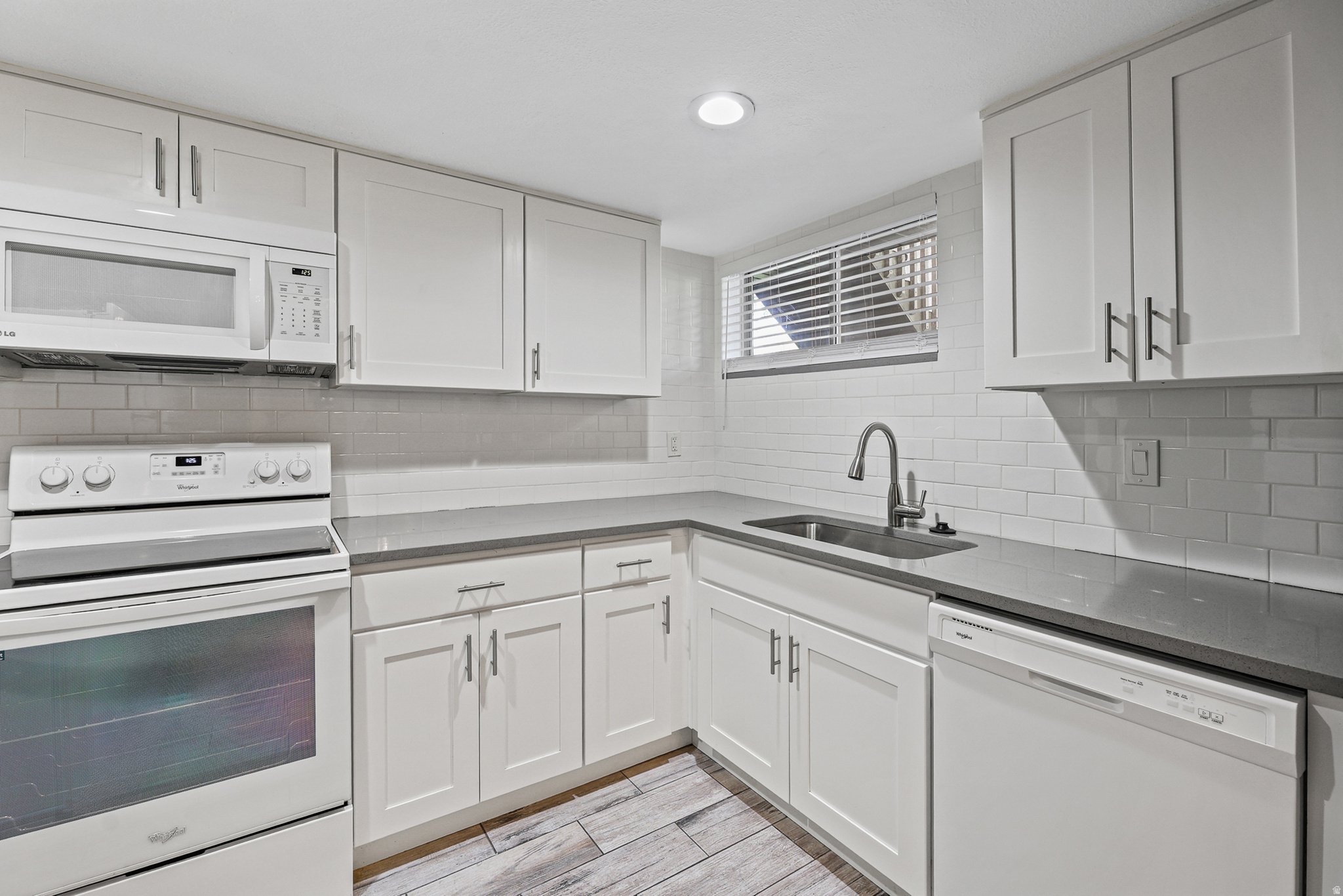 Stylish kitchen with abundant cabinet space, dishwasher, and modern finishes throughout.