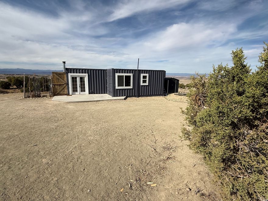 Motivated Seller!  This is a Container Home on 40.54 acres southeast of Duchesne! It is only a year old! Completely off grid!  Includes a septic system, solar power, and generator back up!  1100 gallon water cistern. 1 bedroom, 1 bath. Open Living room/Kitchen/Dining. There is a build on area for storage, studio, shop, or whatever your needs are! This home meets ADA requirements.  Handicap ramp, Accessible placements of appliances and fixtures. A barrier free continuous access throughout the home for individuals with mobility limitations.  Connex is excluded.  The RV and one other tiny home are excluded. This home qualifies for a loan.  Ask us!