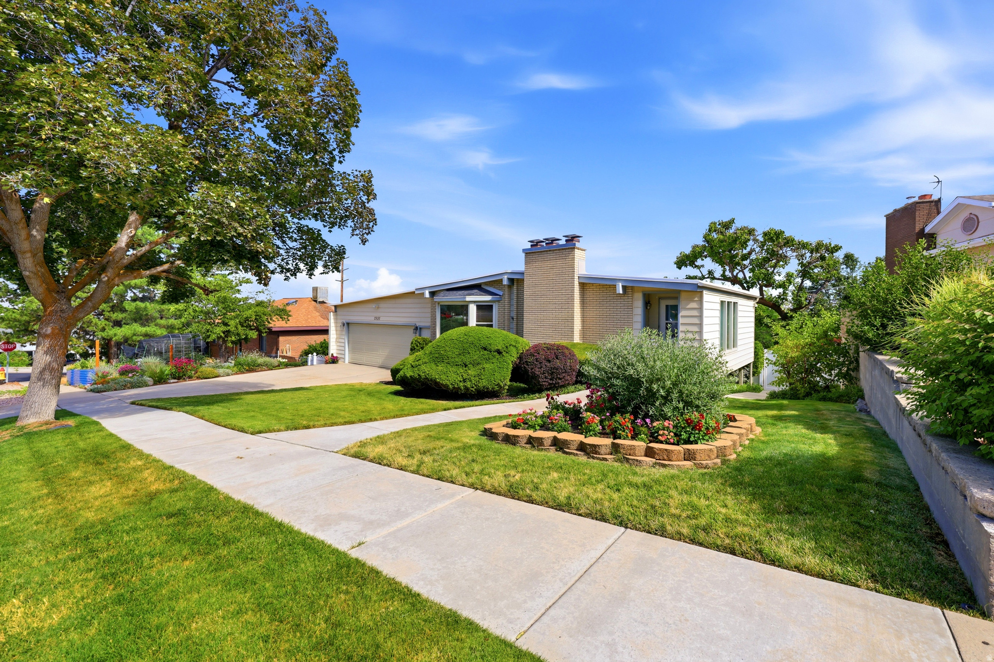 Ranch-style residence featuring a brick facade and a two-car garage