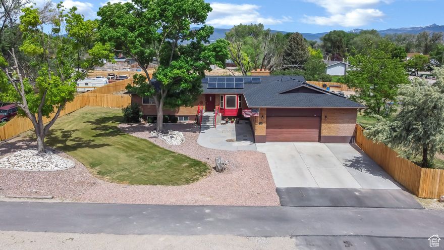 This spacious 6-bedroom, 2.5-bath home has 3,648 sq. ft. of living space and sits on just over half an acre in a great Gunnison Valley location. All the big-ticket upgrades are already done for you-new roof, owned solar panels, new on-demand water heater, newer furnace and A/C, and new windows-so you can move right in and enjoy. Inside, there's plenty of room to spread out. The upstairs has fresh paint and new carpet, giving it a clean, comfortable feel. There's also a separate basement entrance, making it perfect if you want to rent out the basement as an Airbnb or even turn the home into two separate rentals by adding a kitchen. One of the best features is the sunroom with a hot tub, a great spot to relax-or to grow plants year-round thanks to all the natural light. The partially fenced yard has garden boxes, mature trees, space for animals, and easy access to a scenic walking path. This home has so much going for it-and at an awesome price, it's a fantastic find.  Square footage provided as a courtesy from county records; buyers are encouraged to get their own measurement.