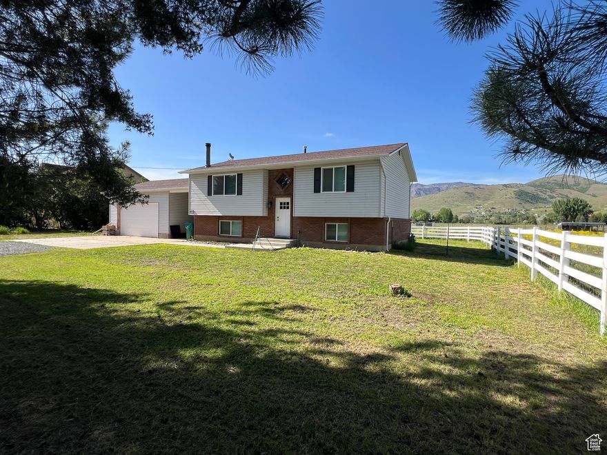 Better price!  Peace and quiet stately Pines shade the front yard from summer sun. Sit on your deck and listen to the "chic, chic, chic" of sprinklers. Updated kitchen and baths are bright and cheery. 4-bedrooms, white vinyl fence, new paint, roof, windows. Big garage with plenty of room. Yard set up for a big dog.  Imagine walking out halter in hand with a bucket of oats as your horse nickers and the chickens look up, scratching away in near their coop and a goat skitters by.  Back patio set up with 50-amp hot-tub breaker.  South-facing driveway = no hard-ice or snow build up. 500 (the "South Lane" as the old timers call it) is so much quieter than the North Lane (to Causey). Eight minutes to Pineview, about 12 to Snow Basin. Come sit a bit... you won't want to leave.