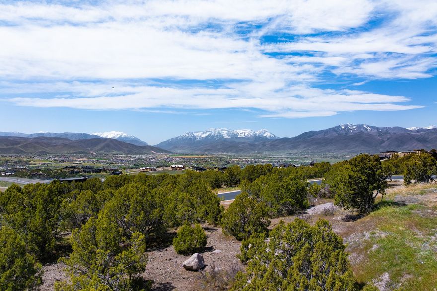 Perched near the top of the prestigious Crown Ridge neighborhood in Red Ledges, Lot 648 offers sweeping panoramic views of Mount Timpanogos, the Wasatch Back, and the surrounding valley from one of the community's most elevated settings. This corner homesite combines privacy, mature trees, open space, and an opportunity to create a truly exceptional custom mountain retreat.  All memberships available with this property which gives access to the community's world-class amenities, including Jack Nicklaus Signature Golf, the Golf Park, tennis and pickleball courts, fitness and wellness facilities, resort-style pool, dining, miles of trails, and private ski amenities at Deer Valley Resort.
