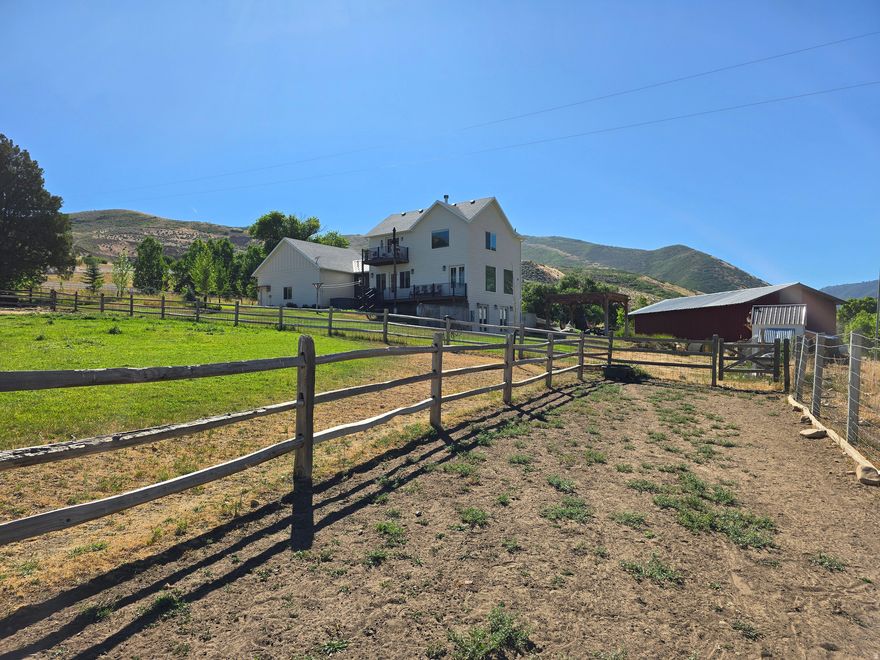 Welcome to this stunning horse property set on just under 7 acres, offering sweeping mountain views and lush green pastures at the base of Daniels Canyon. This serene retreat provides convenient highway access while still giving you the peaceful feeling of your own private rural escape. The property features multiple outbuildings including a large barn, she shed/art studio with solar, tack shed and many animal shelters. There is an EV Charger in the garage, reliable and fast Starlink Internet, the ability to board horses, mature shade trees, fruit trees, multiple outbuildings, and a picturesque seasonal stream running right through the property. With 15 valuable water shares, you have all you need to maintain vibrant pastures, a flourishing garden, or expand your agricultural dreams. Whether you envision a hobby farm, a horse boarding facility, or simply extra space to relax and enjoy, the possibilities are endless. Plus, you'll love the quick access to nearby reservoirs, year-round recreation, and some of Utah's most incredible ski resorts. This unique property offers the perfect blend of beauty, convenience, and true country living. Square footage figures are provided as a courtesy estimate only and were obtained from the building plans. Buyer is advised to obtain an independent measurement.