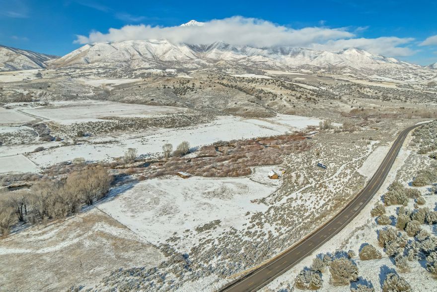 *Multiple offers received. Highest and best due by Monday March 9th at 5:00*  A river runs through it-well, Thistle Creek does! This unique nearly 37-acre fully fenced property combines natural beauty, abundant water, and endless potential, all just 15 minutes from Spanish Fork.  Thistle Creek Farm is ready for your dream home, ranch, or hobby farm. The property features two pastures divided by the creek, historically planted with garlic, alfalfa, and grass, and comes complete with a large wheel line for irrigation.  Mature shade trees create a peaceful grove around a fire pit, perfect for relaxing evenings under the stars. The property also boasts large beaver ponds, ideal for swimming, fishing, or wildlife watching. You'll regularly see wild turkey, deer, and occasionally elk, while Thistle Creek itself is home to large wild trout. The farm borders thousands of acres of public land, offering unparalleled access to outdoor recreation.  This property is located within the Nebo School District boundary. It sits in Utah County's RA-5 zone, where subdivision into 5-acre lots may be possible. With easy access and frontage on Highway 89, it's just minutes from the mouth of Spanish Fork Canyon. A test well has already confirmed water at approximately 80 feet. Power lines are located roughly 300 feet west of the property for convenient connection.