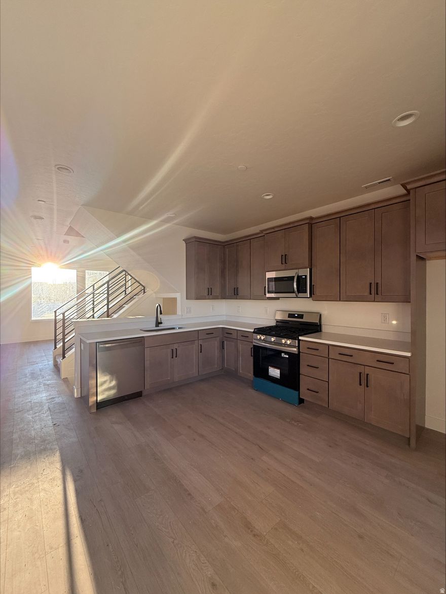 Now Selling  The Manhattan-Sky End Unit in Downtown Daybreak! Be Part of the Excitement in the New Downtown Daybreak Community, only a Short Walk from the Bee's Ballpark. This Stylish 3-Bedroom, 2.5-Bath Home with a Flex-Room is Designed with 9-Foot Ceilings on Every Floor and Open Railing for a Bright, Elevated Feel. The Highlight is the Private Sky-deck, Offering Beautiful Views of Downtown Daybreak - the Perfect Spot to Relax, Entertain, and Take in the Energy of the Community. Home is Complete. Home to be used as a temporary model, builder requests leaseback through May 2026.