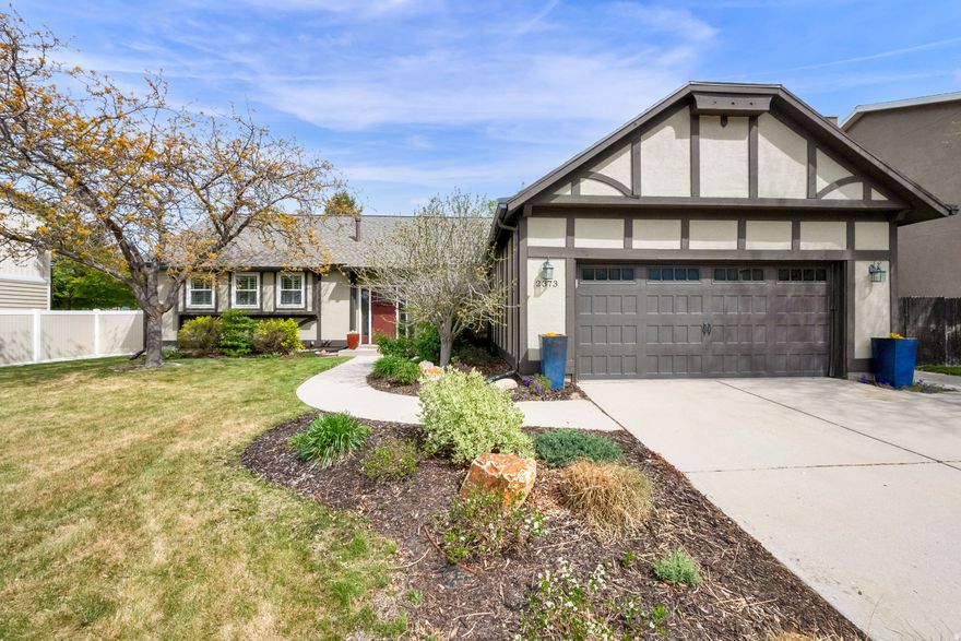 This pristine Dimple Dell Village rambler is situated in an idyllic quiet Sandy neighborhood. The mountain peak views from the front yard and backyard are stunning. Step inside to beautiful laminate wood floors throughout the main level, updated kitchen with granite countertops, under-counter lighting, attractive cabinetry with crown molding and stainless steel appliances - all included in the sale.  Pella doors, plantation shutters, recess lighting and a fireplace with mantel set in beautiful molding are just some of the main level highlights. The primary suite is spacious with ample storage, cozy electric fireplace, walk-in closets and en suite three-quarter bath. The lower level has two bedrooms both with large egress windows, a spacious storage room with shelving included, updated three-quarter bathroom and a large recreation room with a gas fireplace with wood mantel and brick hearth. It's the perfect space for games, entertaining and watching your favorite movies and shows. The backyard is north facing with mature trees (including two apple trees), perennial flowerbeds, veggie and herb garden space and a spacious Trex deck (wired for a hot tub) directly off of the back sliders.  An additional private patio is found on the east side of the home and offers more outdoor dining and grilling possibilities. Updates to the home include; roof 2023, rain gutters 2025, exterior paint 2024, HVAC (furnace, humidifier, water heater and AC unit) 2021, new fireplace insert in living room 2022, new LG appliances - range, microwave, refrigerator 2025 and washer and dryer 2023. (all included in the sale) Pella sliding doors in dining and living room and interior Pella door to garage installed in 2022. Carpet in family room down replaced in 2022. Updates to landscaping in 2022 and 2023 included professional install of low water-usage plants, trees and drip-line in front gardens, rain barrel and upgrade to the irrigation system. Radon mitigation system installed in 2021. The garage has excellent attic space for storage, conveniently accessible via built-in pull-down stairway. The location can't be beat with close access to Little Cottonwood Canyon for skiing, hiking and camping, great public and private schools and public parks. This property is a must see and won't disappoint. Showings to begin at the Open House on Saturday April 25th from noon to 3pm. Private showings available to be scheduled after the Open House.  See attached video tour.