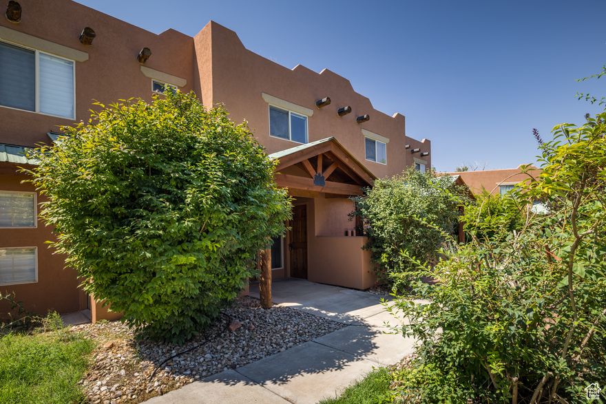 STUNNER ON THE PARKWAY!  Set on the coveted open green space with the tranquil sounds of Mill Creek, this beautiful townhome is polished to perfection. Thoughtfully remodeled from top to bottom opening the living space, restructuring the kitchen layout and functionality, to superior finish.  Featuring custom Westside Woodworks designed and crafted doors, trim, kitchen and bathrooms- providing purposeful placement and appeal. Gorgeous granite tops, beautiful wood grain luxury vinyl tile, fresh paint, and canned lighting throughout.  The kitchen heightens your senses with the second story sky light brightening the space and the mood.  The second story offers a sweet landing with space for lounging or a workspace, a guest suite with adjacent bath featuring an enlarged walk-in shower, as well as the primary bedroom en-suite with sliding glass doors to the balcony overlooking the lush green space and Mill Creek lined with Cottonwood trees.  This special home also includes a ground floor patio, right on the lawn, a utility room with storage, a dedicated covered parking space, as well as a separate storage shed. Mill Creek Pueblos offers a community pool and one of Moab's most ideal locations across from the local's commercial corner with Dave's Corner Market, Milt's Stop & Eat, and Rize Studio.  This convenient location has direct access to the Mill Creek Parkway and a quick ride up to Sand Flats Recreation Area. Enjoy the ease of townhome living with the park-like setting out your back door!