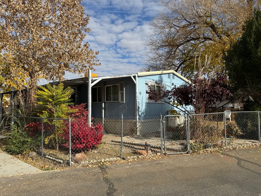 Established 3 bedroom 2 bath manufactured home in Grand Oasis Housing Community.  Move in ready with with additional storage and established trees and landscaping.   There are two parking spaces, a grassy area, and a shed for storage.  Views of the Moab Rim and multiple amenities for families add to the value of this home.  Buyer must be approved for rental of lot.  Lot rental is $797 per month which includes garbage and water.  The community amenities include a playground, basketball court, pool, laundry, fitness center, and a clubhouse to rent for events. All park rules apply.  Square footage figures are provided as a courtesy estimate only and were obtained from agent measurements.  Buyer is advised to obtain an independent measurement.