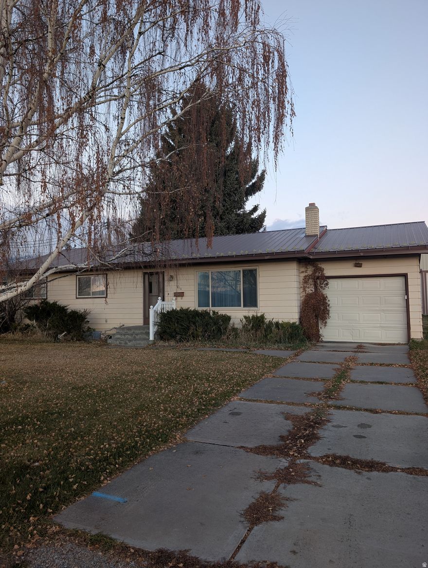 Welcome to this charming home showcasing a well-maintained exterior with durable metal roofing and siding. This residence features a spacious primary bedroom conveniently located on the main level, complemented by an open-concept kitchen perfect for entertaining. Enjoy the comfort of new carpeting laid in a couple downstairs rooms, enhancing the cozy ambiance throughout.  With two family rooms, one of which can easily be converted into an additional large bedroom, this home offers flexibility for your living needs. The property also includes a generous 30 x 30 detached shop, providing ample space for hobbies, extra parking, and additional storage. Don't miss this rare opportunity to own a well-cared-for home with great potential in a desirable location!