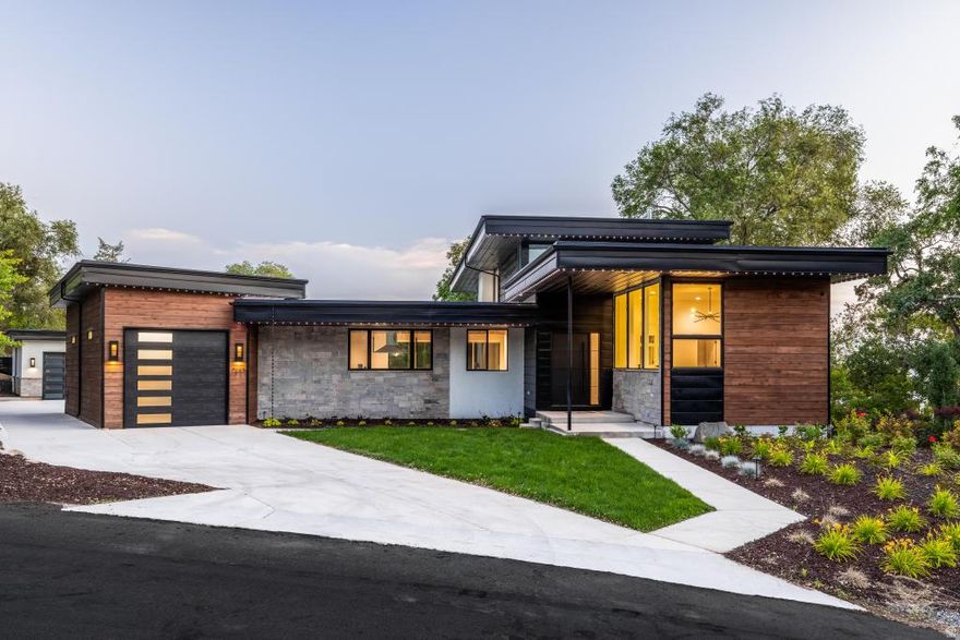 *** Priced $500k+ Below appraisal *** Own the Lifestyle: A Modern Masterpiece at 1668 E Forest Hills Dr Step into a world of unparalleled luxury and effortless sophistication with this Parade of Homes stunner, completed in 2024 and redefining what it means to live well. Nestled in the sweet spot between Holladay and Millcreek, this 6,357+ sq. ft. private compound is your ultimate escape-a place to unwind, entertain, and command the moment. This isn't just a home; it's a vibe, a statement, a legacy. The Vision: From the moment you arrive, the sleek architecture and seamless indoor-outdoor flow grab you. Expansive picture windows frame jaw-dropping mountain views, flooding the open-concept living spaces with natural light. Every detail screams intentionality-modern luxury finishes, soaring vaulted ceilings, and covered terraces that beg for sunset cocktails or morning coffee. This is a home designed for how you live today-bold, connected, and always elevated. The Heart: The gourmet kitchen is a showstopper, anchored by a jaw-dropping quartz waterfall island that's as functional as it is Instagram-worthy. Commercial-grade appliances and eat-in seating make it the hub for everything from casual brunches to late-night gatherings. It's not just a kitchen; it's where memories are made. The Retreat: With five bedrooms and five-and-a-half baths, this estate is built for flexibility. The luxurious primary suite is your personal sanctuary, while two distinct bedroom wings offer privacy for family, guests, or that VIP houseguest you're dying to impress. Need more? An office, a theater room, and a bonus room with a wet bar and beverage cooler give you space to work, play, or just flex. The Playground: Step outside to 0.56 acres of pure possibility. The backyard's custom concrete pad is primed for pickleball action-ready to become your private court for epic matches or left as a versatile space for whatever fun you dream up. Add to that a sprawling grassy play area, a soothing water feature, and an outdoor sound system, and this backyard is your personal resort. Whether it's high-energy game days or chill evenings under the stars, this space delivers. Plus, two garages-a pull-through with extra parking and an oversized second-handle all your toys and then some. The Location: Tucked in Millcreek, you're minutes from everything-Salt Lake City's buzz, Park City's slopes, and the serenity of nature-all while feeling a world away in your private oasis. This is where convenience meets tranquility, with top schools (William Penn Elementary, Evergreen Middle, Olympus High) and a vibrant community at your doorstep. The Opportunity: This isn't just a home-it's a lifestyle upgrade. Perfect for the discerning buyer who wants it all: modern design, resort-style amenities, and a location that checks every box. Schedule your private tour today and experience the energy of 1668 E Forest Hills Dr. This is your moment-own it.