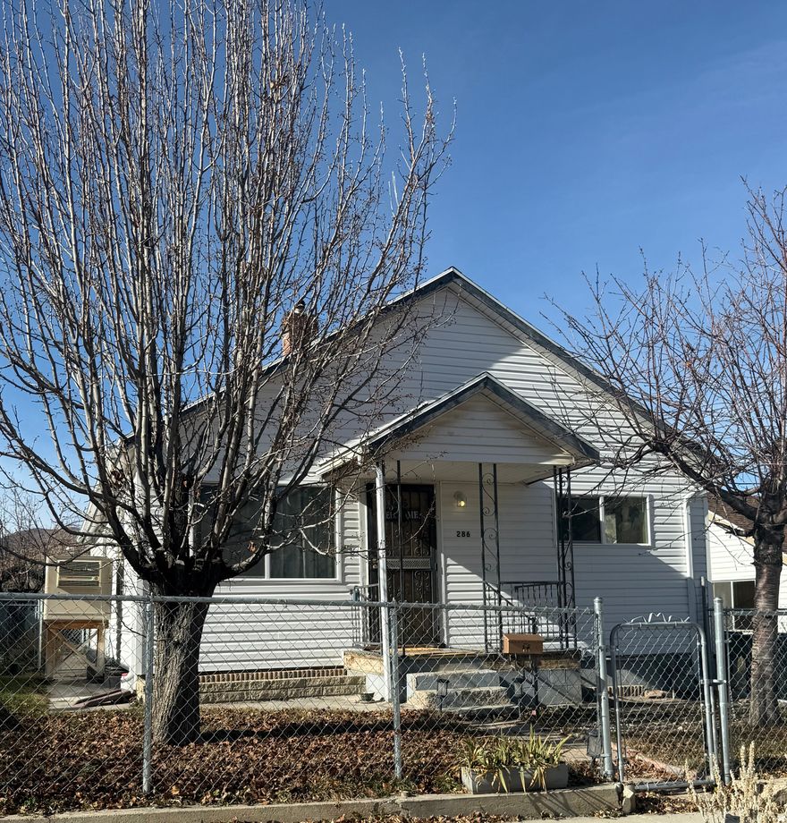 Square footage figures are provided as a courtesy estimate only and were obtained from ~COURT HOUSE~ .  Buyer is advised to obtain an independent measurement.  Charming 1941 Home with Mountain Views  This spacious 5-bedroom, 2-bathroom home offers timeless character with modern potential. Built in 1941, it features classic charm along with practical updates. The property includes a partially landscaped yard, partial fencing, and established fruit trees-perfect for those who enjoy outdoor living and gardening. Located in a neighborhood with curb and gutter, sidewalks, and stunning views of the surrounding mountains, this home is a rare find with room to make it your own. Home also has a covered patio and covered porch.