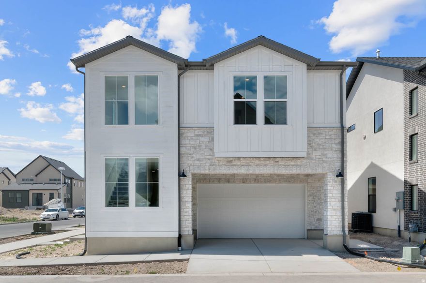 Come see this stunning Sundance Farmhouse-style home offering the perfect blend of modern upgrades and timeless design. The bright and open kitchen features white laminate cabinetry, sleek quartz countertops, and stainless steel gas appliances-ideal for both daily living and entertaining. A combination of laminate hardwood, vinyl tile, and plush carpet flooring provides style and comfort throughout. This thoughtfully designed home includes a convenient side entry, recessed can lighting, and dedicated Christmas light outlets for effortless seasonal decorating. Energy-efficient features, including a tankless water heater, enhance comfort while helping reduce utility costs. Elegant Craftsman-style baseboards and door casings add character, complemented by satin and brushed nickel hardware finishes throughout. The spacious owner's suite offers a spa-inspired feel with quartz surrounds in the bathroom, creating a relaxing retreat. This is a beautifully upgraded home with functional features and stylish finishes all in a great community!