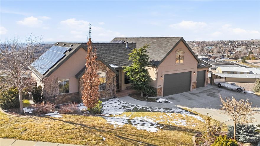 This Parade of Homes has amazing mountain and valley views to create a private oasis on a 1.10-acre lot. This home boasts beautiful trim work and built-in cabinetry throughout. The concrete fence around an area of the backyard provides privacy complete with a cozy pergola where you can sit by the fire and enjoy the sunsets in the evenings. Backyard has mature trees, a large raised garden (sprinklers have an app) next to a shed with a roll-up garage door for storing outdoor equipment. Located on the East Layton bench, a short walk (200 ft) to the Bonneville Shoreline Trailhead. This home is truly made for both entertaining and everyday living, with jaw dropping views out all the back windows.  Enjoy an open floor plan, high ceilings and a chef's kitchen with stainless steel Thermador appliances, a basement kitchen/bar with Sub-Zero mini fridge. Main level features floor-to-ceiling windows, a generous primary suite, and additional bedroom (currently being used a an office). Upper level has a large bonus room, storage closets and a spacious bedroom with a view and walk in closet. The basement has 2 bedrooms (1 is currently being used as the exercise room) kitchen/bar, bathroom, living room and storage area. Wine enthusiasts will be delighted by the custom brick wine cellar (cold storage), complete with a barreled ceiling. Other notable features of this remarkable property include a three car oversized garage, a natural gas fire pit for cozy evenings outdoors, cement fence, drip watering system for trees on hill, Mitsubishi Electric solar panels for energy efficiency (around $50/month), a whole-home humidifier, a Kinetico soft water system, split HVAC system (furnace in the lower floor for main and lower level, furnace and & A/C in bonus level) and built in speakers throughout the home (Sonos Audio System w'app) for added convenience and entertainment.