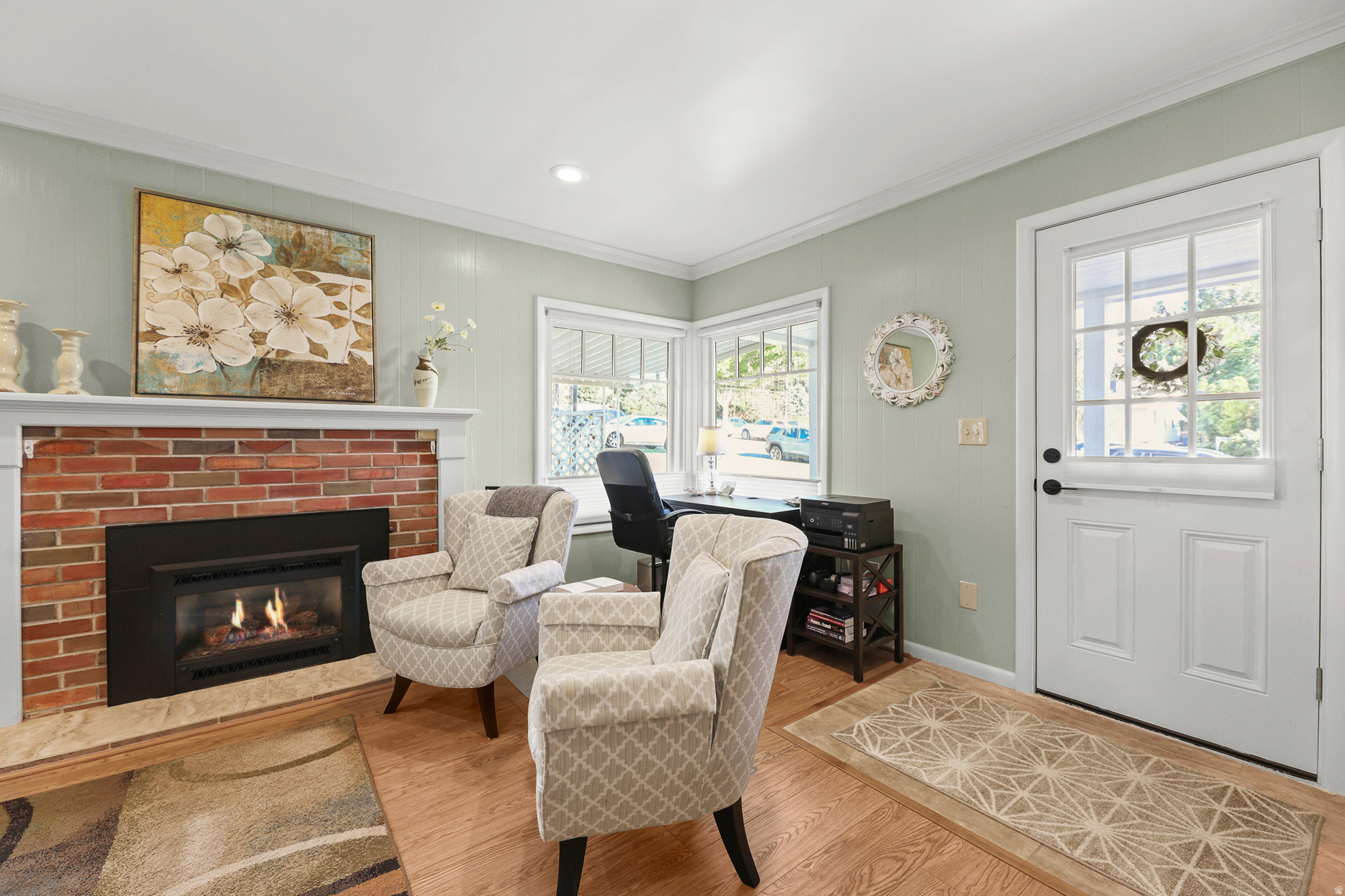Living area featuring a brick fireplace with a black insert and a light-colored mantel
