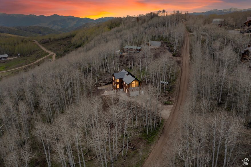 **Price Reduced** Fully Finished ** Experience the perfect blend of modern luxury and mountain serenity in this brand-new mountain modern home, thoughtfully designed and nestled on a private, tree-filled lot with breathtaking mountain views. Tucked away for ultimate privacy, this property offers the peace of a secluded retreat with the convenience of year-round access on an alternate plow route. Step inside to a striking great room where vaulted ceilings, a cozy fireplace, and expansive windows create a light-filled sanctuary that connects seamlessly to the natural surroundings. Real hardwood floors flow throughout the home, enhancing its warmth and timeless elegance. The spacious layout includes large bedrooms with oversized closets, providing ample storage and comfort. The primary suite is a true escape, featuring its own private balcony, a generous walk-in closet, and a luxurious en-suite bath with separate soaking tub and shower. Designed for ease and function, the laundry room is conveniently located on the second floor, just steps from the bedrooms. The daylight basement expands your living space with a second family room, an additional bedroom, and a full bath - perfect for guests, a home office, or a media retreat. Built with attention to every detail, this home combines the beauty of nature with the sophistication of modern living. Whether you're relaxing by the fire, entertaining in the open living spaces, or enjoying the panoramic views from your balcony, this home is mountain living at its finest.