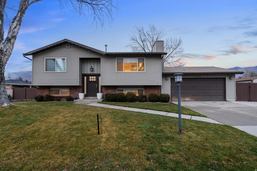 Completely remodeled inside and out in 2019, this stunning home showcases a timeless white and gray palette with modern, thoughtful upgrades throughout. Improvements include newer vinyl windows, all custom interior and exterior doors, a back deck with covered roof, updated exterior paint, lighting, and professionally designed landscaping.  Step inside to a bright, open living space featuring recessed lighting and a stylish shiplap accent wall. The kitchen is a true centerpiece with white cabinetry, quartz countertops, gray glass subway tile backsplash, modern lighting, and upgraded Samsung stainless steel appliances. Gray wood-look tile flooring flows seamlessly through the kitchen, dining area, and entryway.  Both full bathrooms were also fully remodeled with new tubs, toilets, brushed nickel fixtures, white tiled surrounds, custom vanities with quartz countertops, and large gray tile flooring. The finished basement offers a cozy gas fireplace framed by a custom shiplap accent wall with a built-in shelf perfect for a flat-screen TV.  Enjoy the fully fenced backyard complete with a Tuff Shed, ideal for storage or hobbies. This home is truly move-in ready and beautifully done from top to bottom.  Square footage figures are provided as a courtesy estimate only and were obtained from county records. Buyer is advised to obtain an independent measurement.